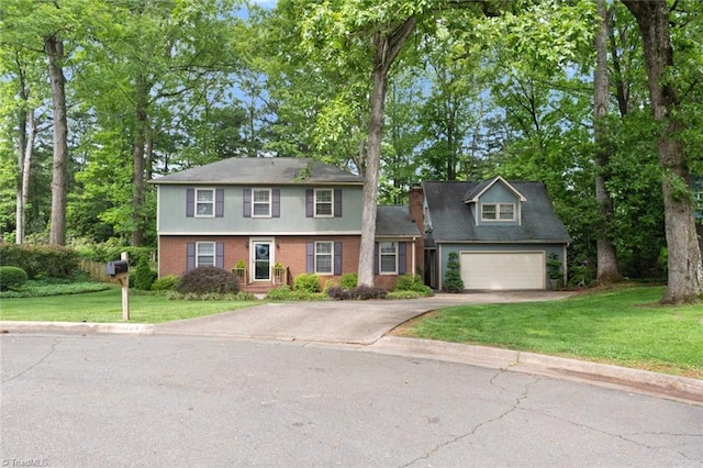 colonial inspired home with a garage, brick siding, a front lawn, and aphalt driveway