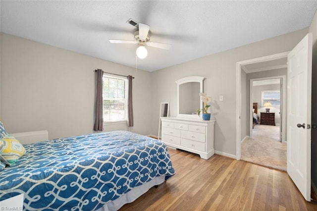 bedroom with baseboards, a ceiling fan, and wood finished floors
