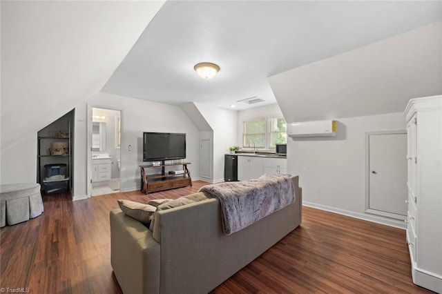 living area featuring baseboards, wood finished floors, lofted ceiling, and a wall mounted air conditioner