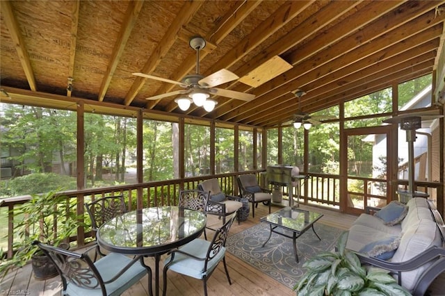sunroom / solarium with a ceiling fan, outdoor dining space, and an outdoor living space