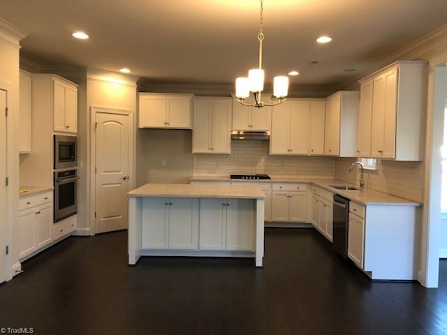 kitchen with appliances with stainless steel finishes, dark hardwood / wood-style flooring, white cabinets, and backsplash