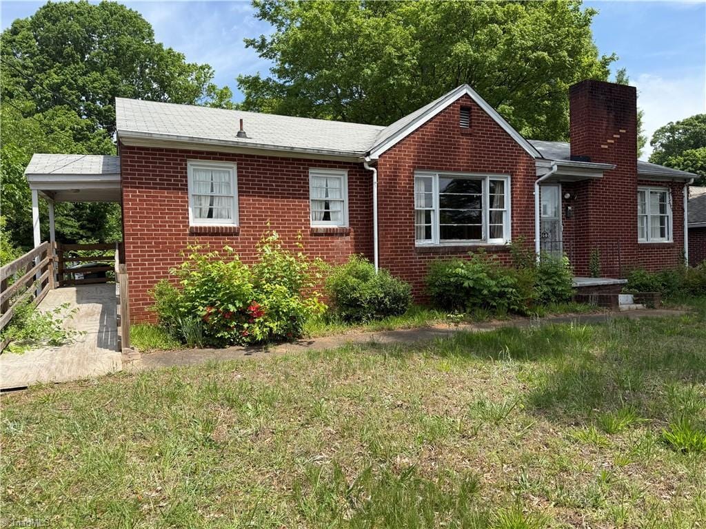 1607 Princeton St, Winston-Salem, NC 27103 - view of front of house with a chimney, brick siding, and a front yard