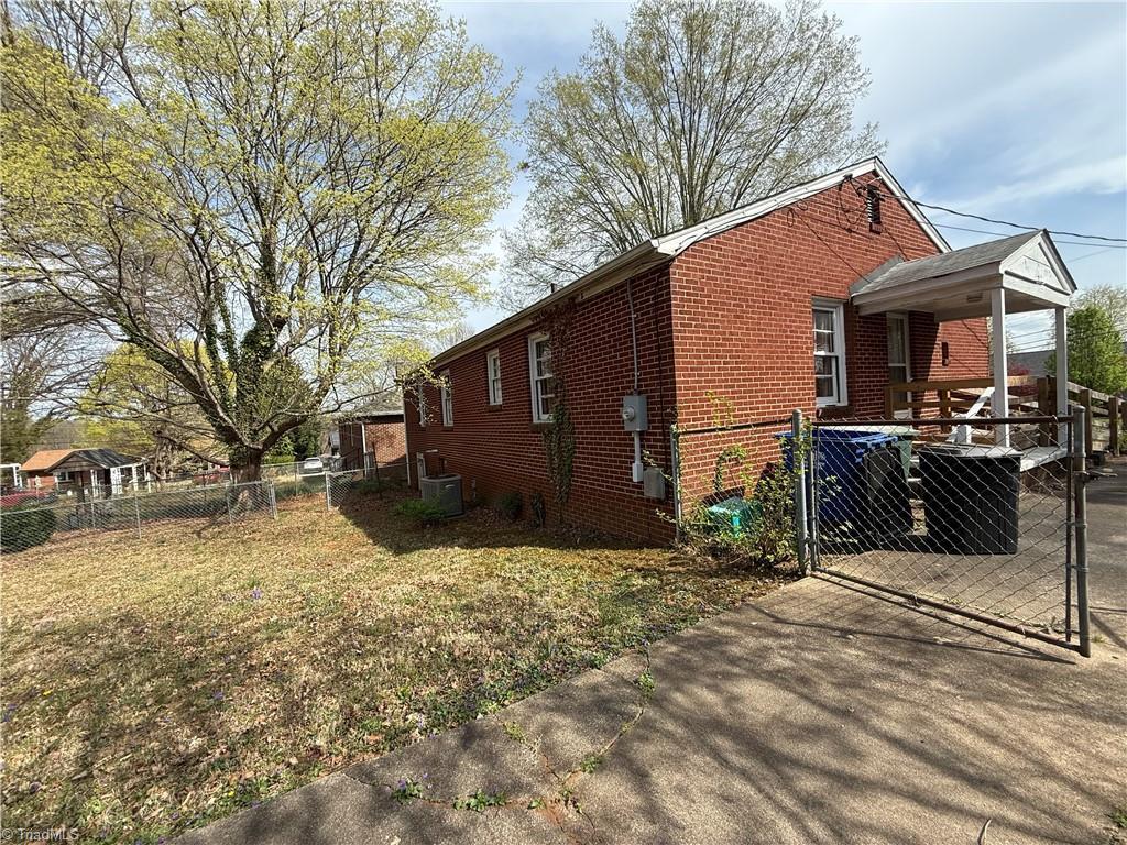 1607 Princeton St, Winston-Salem, NC 27103 - view of property exterior featuring a gate and brick siding