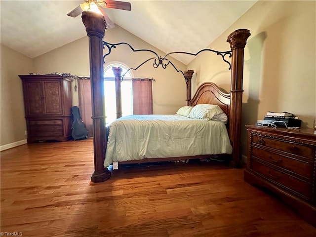 bedroom with hardwood / wood-style flooring, ceiling fan, and vaulted ceiling