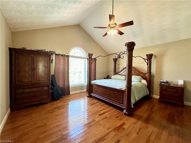 bedroom featuring lofted ceiling, dark hardwood / wood-style floors, and ceiling fan