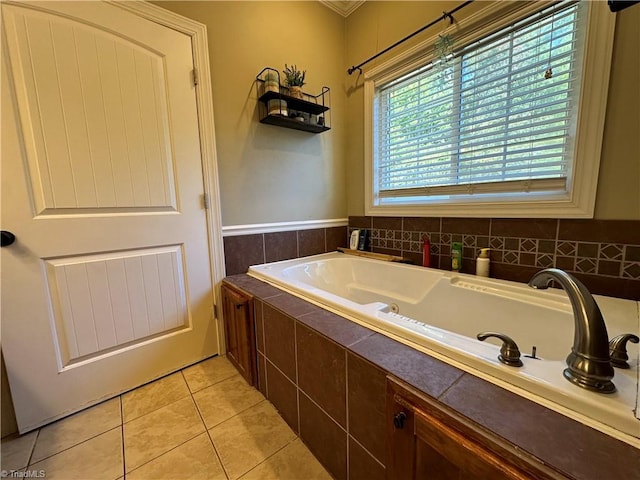 bathroom with tiled tub and tile patterned floors