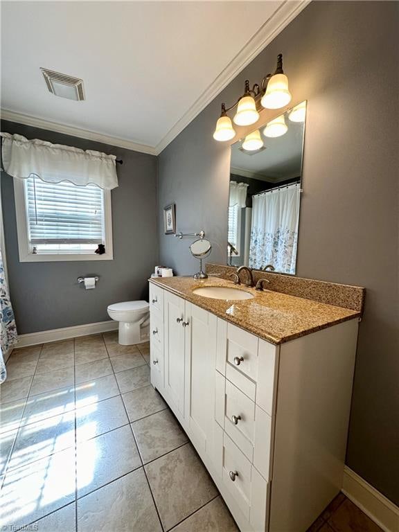 bathroom featuring vanity, crown molding, toilet, and tile patterned floors