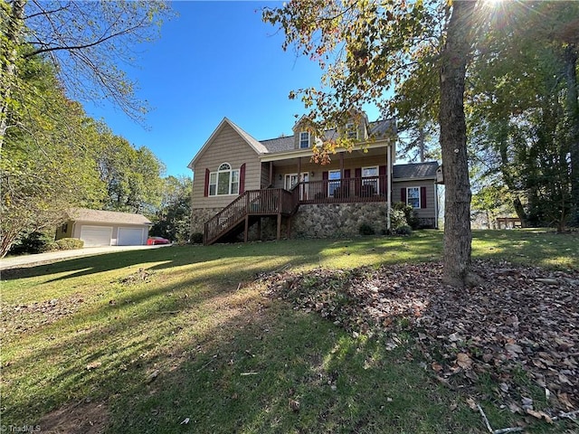 view of front of house featuring a front yard, an outbuilding, and a garage