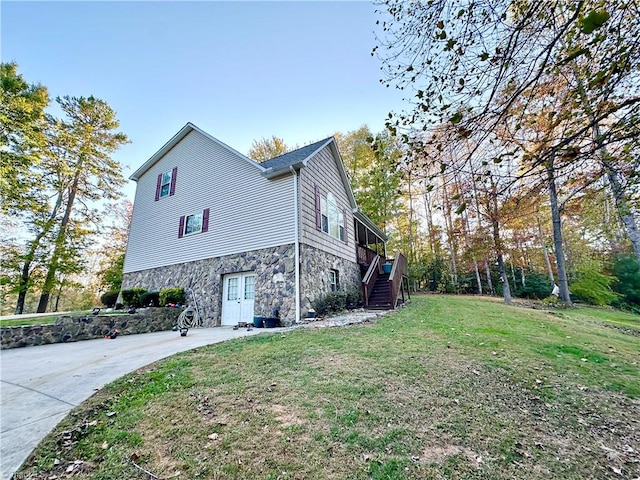 view of side of home with a lawn