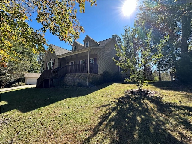 view of side of property featuring a garage and a lawn