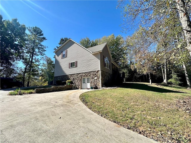 view of property exterior featuring a yard and a garage