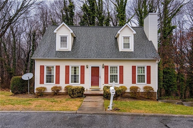 new england style home featuring a front lawn