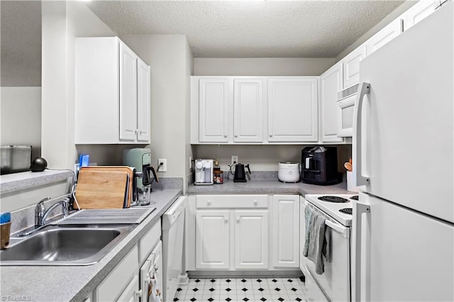 kitchen featuring a sink, white appliances, light countertops, a textured ceiling, and white cabinetry