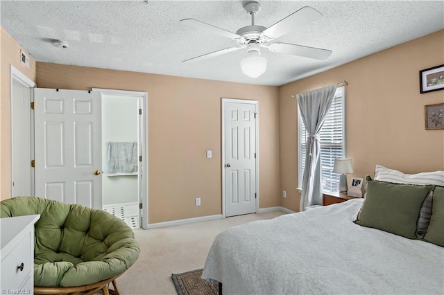 bedroom with a textured ceiling, baseboards, visible vents, and light carpet