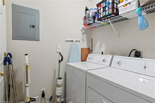 clothes washing area featuring laundry area, washer and clothes dryer, and electric panel