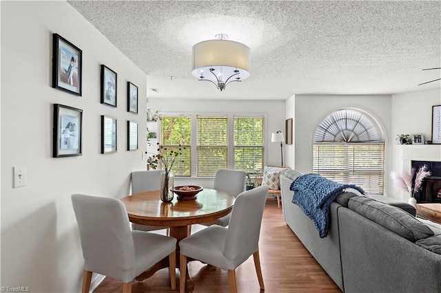 dining area featuring a textured ceiling and wood finished floors