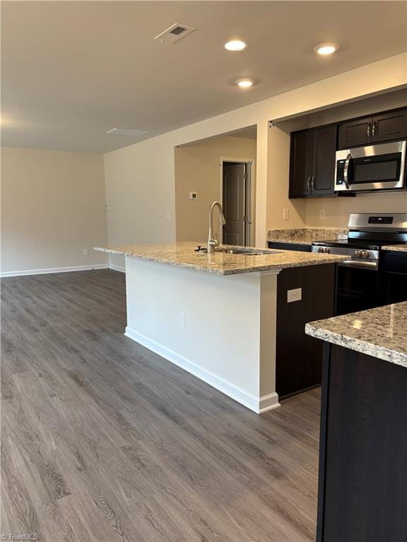 2892 Tysinger Rd, Denton, NC 27239 - kitchen featuring appliances with stainless steel finishes, dark wood-style flooring, a center island with sink, baseboards, and recessed lighting