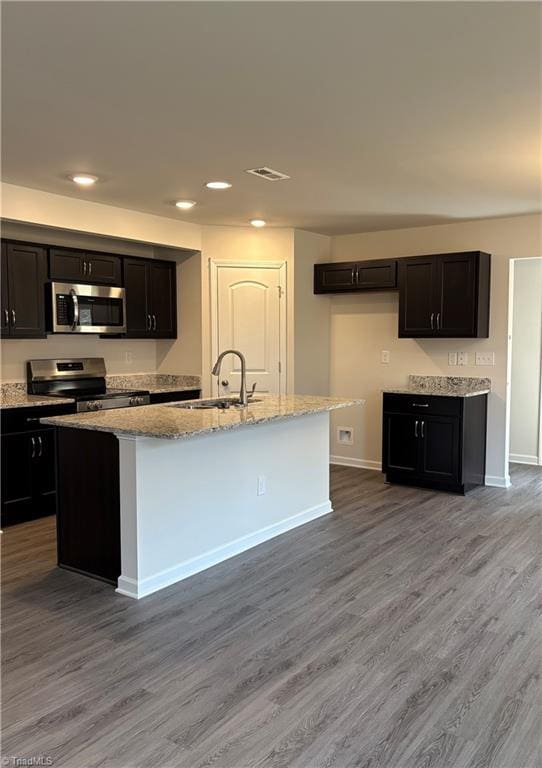 2892 Tysinger Rd, Denton, NC 27239 - kitchen with stainless steel appliances, a sink, wood finished floors, baseboards, and recessed lighting