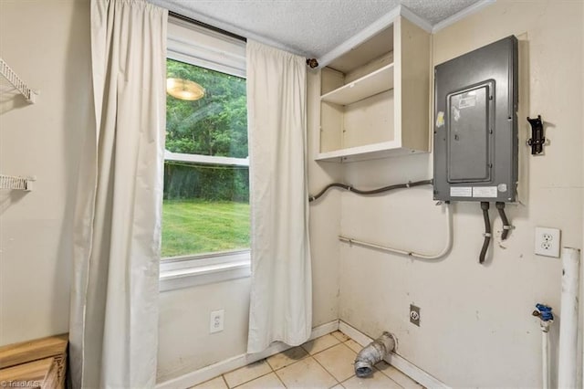 clothes washing area with tile patterned floors, electric dryer hookup, a wealth of natural light, and electric panel