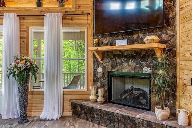 detailed view of wood finished floors and a stone fireplace