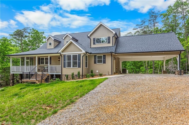 view of front of home with gravel driveway, covered porch, a front lawn, roof with shingles, and a carport