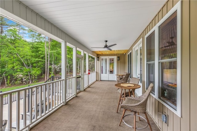 sunroom featuring a ceiling fan and french doors