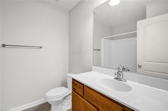 full bath with vanity, baseboards, tile patterned flooring, walk in shower, and toilet