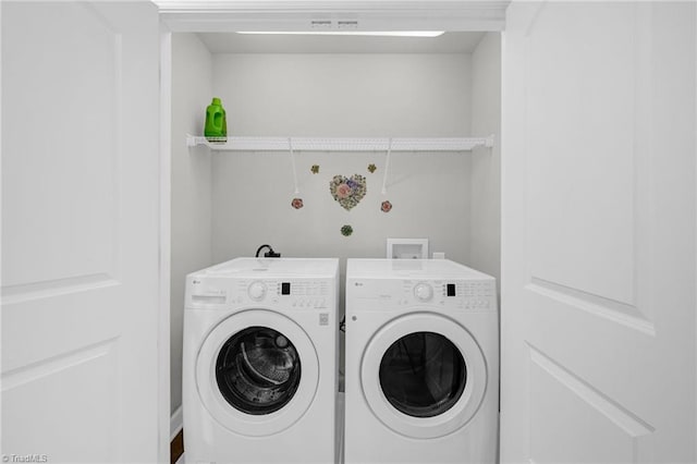 laundry area featuring washing machine and dryer and laundry area