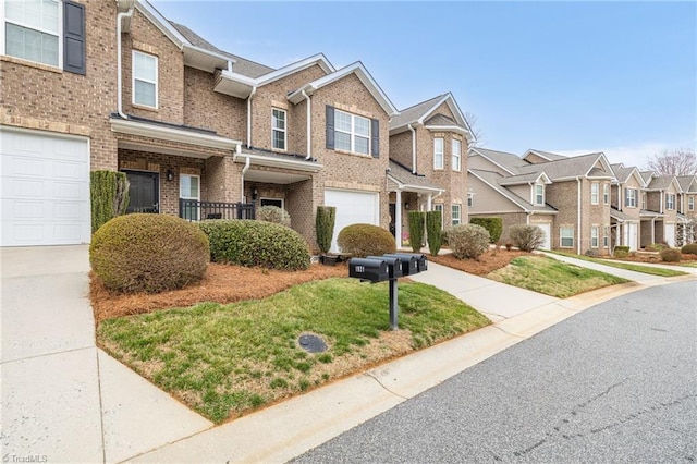 townhome / multi-family property with a garage, brick siding, a residential view, and driveway