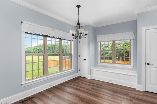 6147 Olde Fields Way, Pfafftown, NC 27040 - unfurnished dining area with a chandelier, dark wood-style flooring, ornamental molding, and healthy amount of natural light