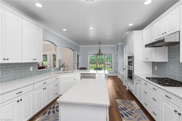 6147 Olde Fields Way, Pfafftown, NC 27040 - kitchen featuring a peninsula, appliances with stainless steel finishes, ornamental molding, recessed lighting, and arched walkways