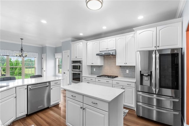 6147 Olde Fields Way, Pfafftown, NC 27040 - kitchen with stainless steel appliances, a chandelier, white cabinets, dark wood-style flooring, and crown molding