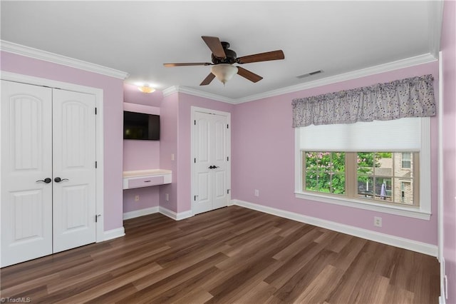 6147 Olde Fields Way, Pfafftown, NC 27040 - unfurnished bedroom with two closets, wood finished floors, crown molding, and ceiling fan