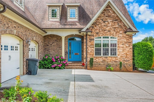6147 Olde Fields Way, Pfafftown, NC 27040 - property entrance with driveway, stone siding, roof with shingles, and an attached garage
