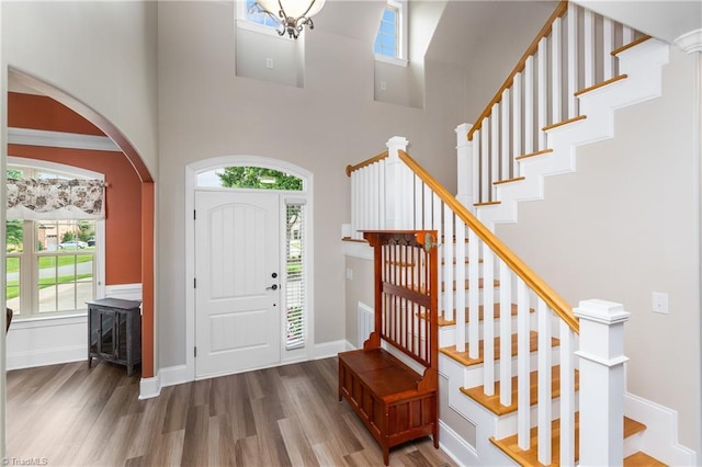 6147 Olde Fields Way, Pfafftown, NC 27040 - foyer entrance with wood finished floors, arched walkways, stairway, and a high ceiling
