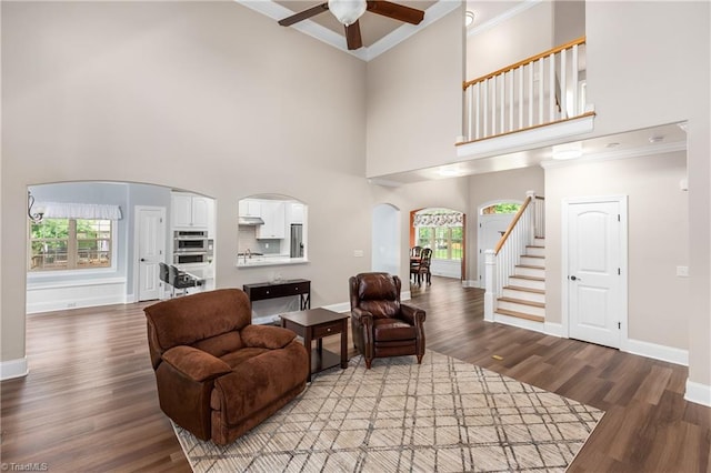 6147 Olde Fields Way, Pfafftown, NC 27040 - living room with arched walkways, ornamental molding, a ceiling fan, wood finished floors, and plenty of natural light