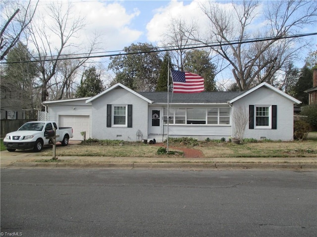 ranch-style home featuring crawl space, driveway, a garage, and a shingled roof