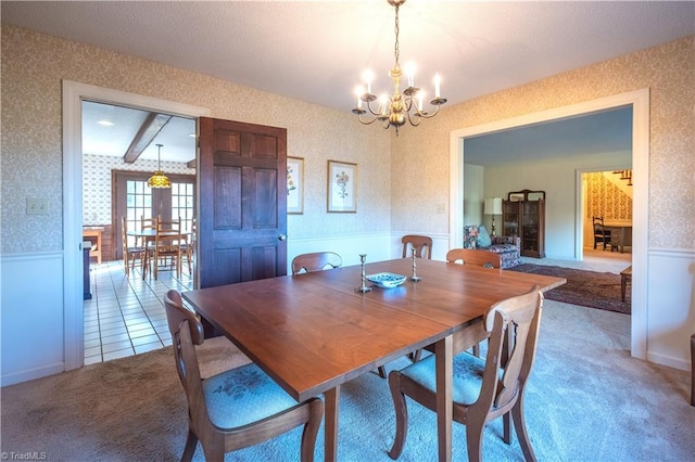 dining area with a notable chandelier and carpet floors