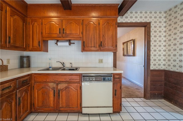 kitchen featuring beamed ceiling, sink, light tile patterned floors, and white dishwasher