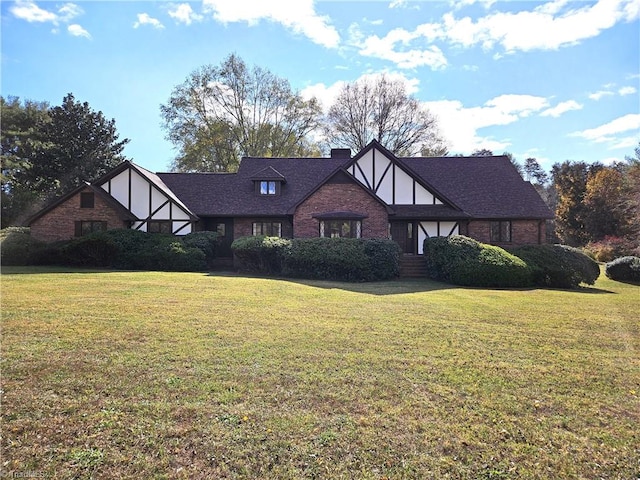 tudor-style house with a front lawn