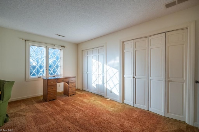 unfurnished office with a textured ceiling and light colored carpet