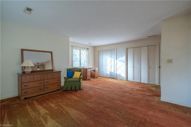 living area featuring a textured ceiling and carpet floors