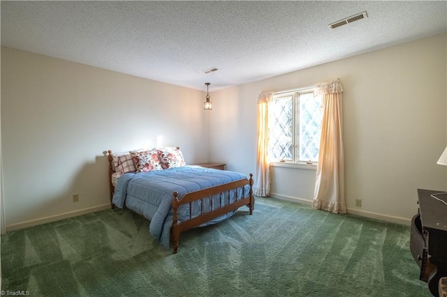 carpeted bedroom featuring a textured ceiling