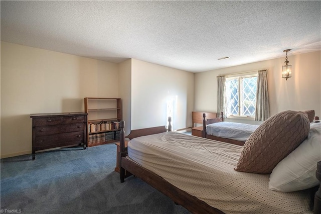 bedroom with a textured ceiling and carpet flooring