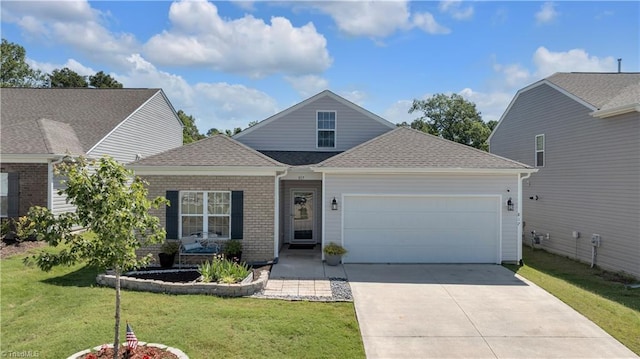 817 Sage Hill Dr, Jamestown, NC 27282 - traditional-style home with a garage, driveway, a front lawn, a shingled roof, and brick siding