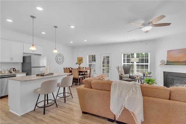 817 Sage Hill Dr, Jamestown, NC 27282 - living area with crown molding, light wood-style floors, a ceiling fan, recessed lighting, and a fireplace