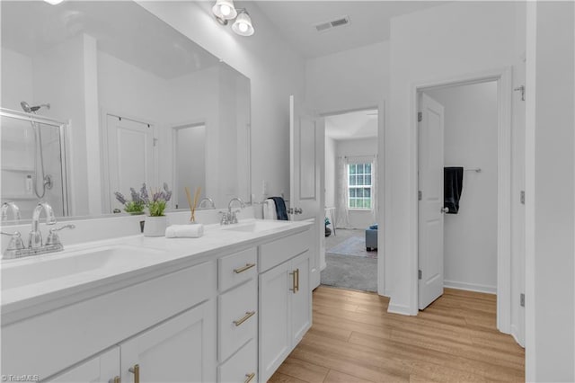 817 Sage Hill Dr, Jamestown, NC 27282 - full bathroom featuring wood finished floors, double vanity, an enclosed shower, and ensuite bathroom