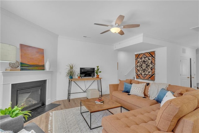 817 Sage Hill Dr, Jamestown, NC 27282 - living room with wood finished floors, crown molding, a ceiling fan, and a glass covered fireplace