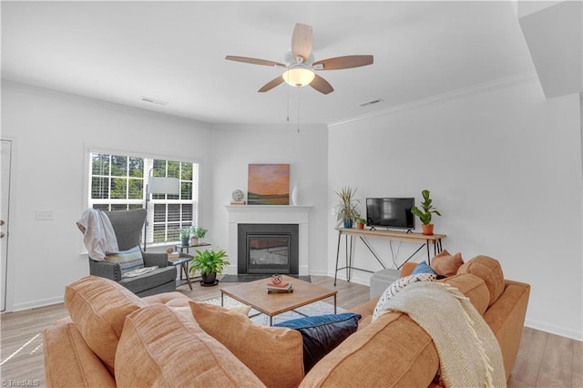 817 Sage Hill Dr, Jamestown, NC 27282 - living area with ceiling fan, wood finished floors, a fireplace with flush hearth, and crown molding