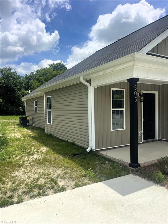 505 White Oak St, High Point, NC 27260 - view of side of home with roof with shingles, a porch, board and batten siding, and a yard